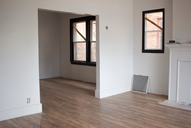 empty room with wood finished floors and baseboards