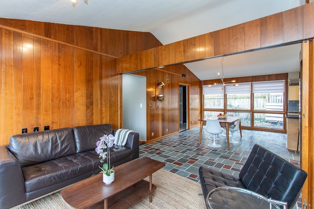 living room featuring wood walls and vaulted ceiling