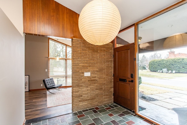 foyer with brick wall