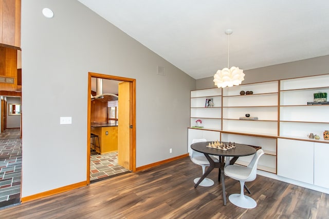 dining room with a notable chandelier, dark wood finished floors, lofted ceiling, visible vents, and baseboards