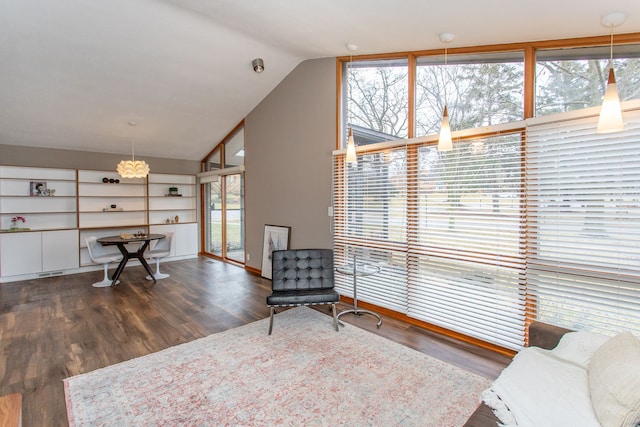 sitting room with lofted ceiling and wood finished floors