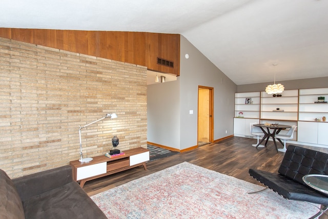 living room with brick wall, visible vents, dark wood finished floors, and baseboards