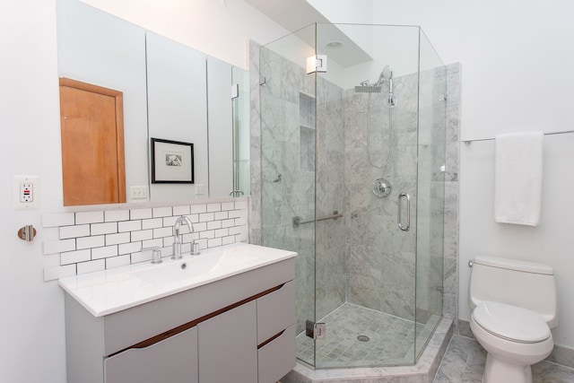 bathroom featuring toilet, backsplash, a shower stall, and vanity