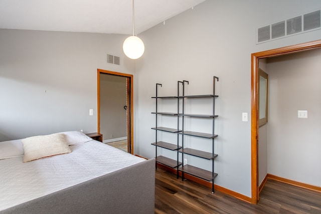 bedroom with dark wood-style floors, high vaulted ceiling, visible vents, and baseboards