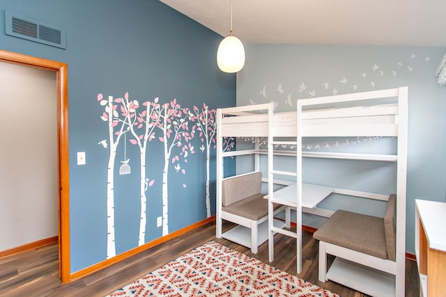 bedroom featuring wood finished floors, visible vents, and baseboards