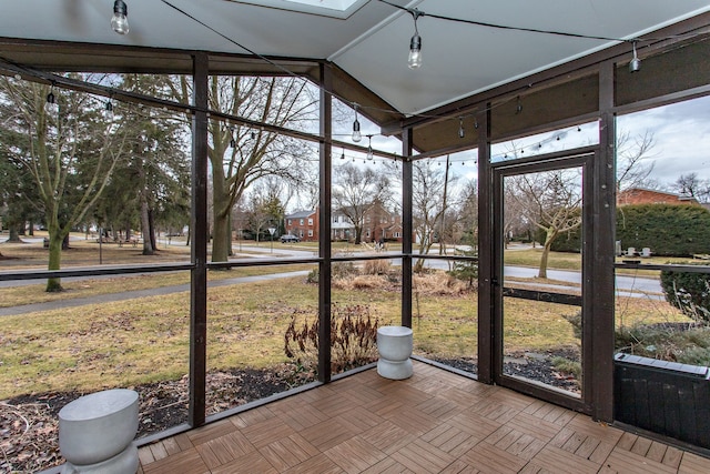 unfurnished sunroom with vaulted ceiling