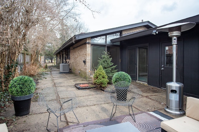 view of patio featuring central AC unit and fence