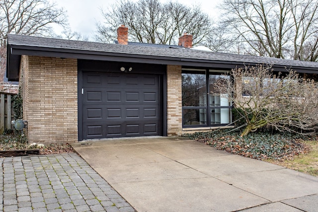 garage featuring concrete driveway