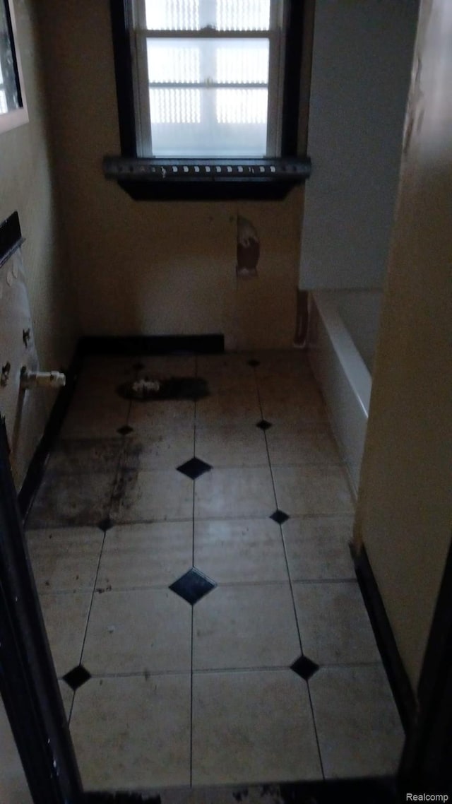 9437 Beaconsfield St, Detroit, MI 48224 - bathroom featuring a bath and tile patterned floors