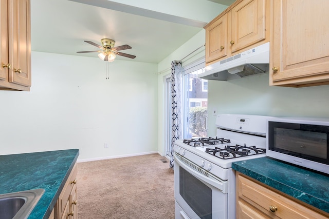 kitchen with white range with gas cooktop, light brown cabinets, under cabinet range hood, a sink, and carpet floors