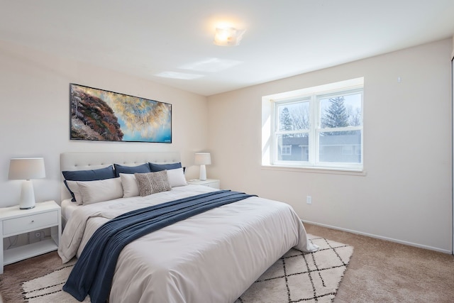 bedroom featuring light colored carpet and baseboards