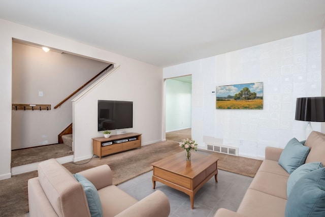 carpeted living area with visible vents, stairs, and baseboards