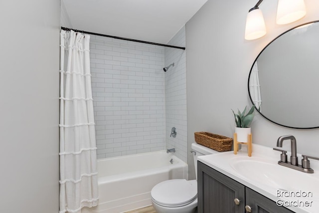 bathroom featuring toilet, shower / bathtub combination with curtain, and vanity