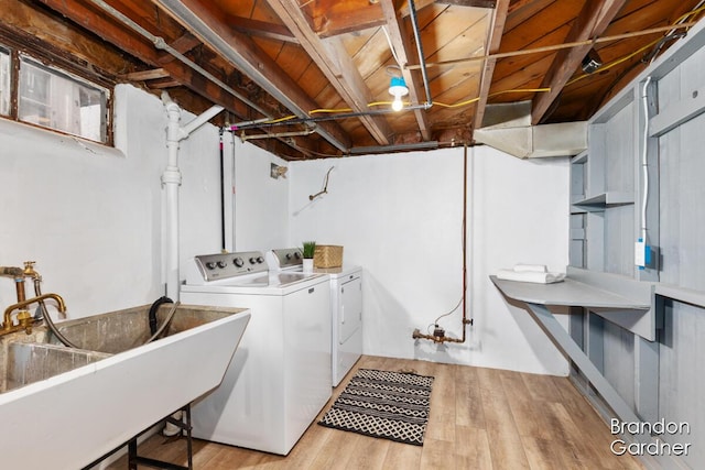 laundry room with wood ceiling, a sink, separate washer and dryer, wood finished floors, and laundry area