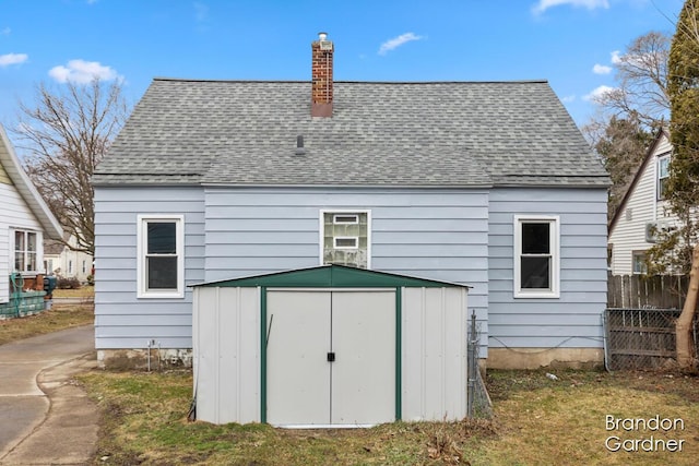 view of shed featuring fence