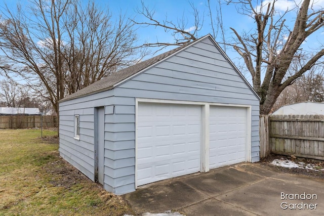 detached garage featuring fence