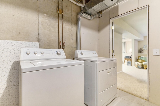 clothes washing area with washer and dryer and light carpet