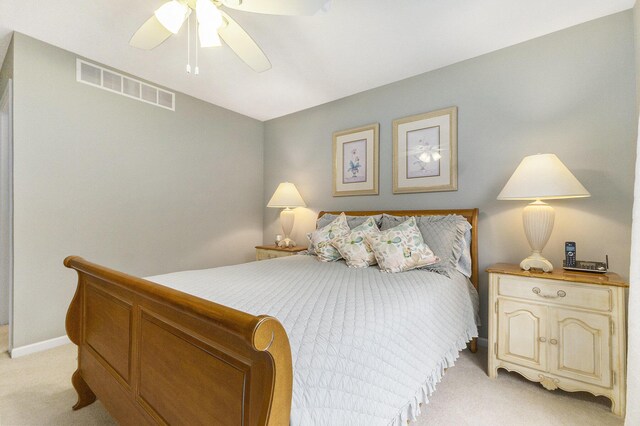 bedroom featuring light carpet, ceiling fan, visible vents, and baseboards