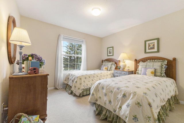 bedroom with carpet flooring and baseboards