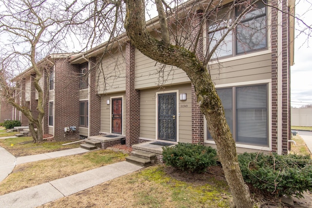 townhome / multi-family property featuring brick siding