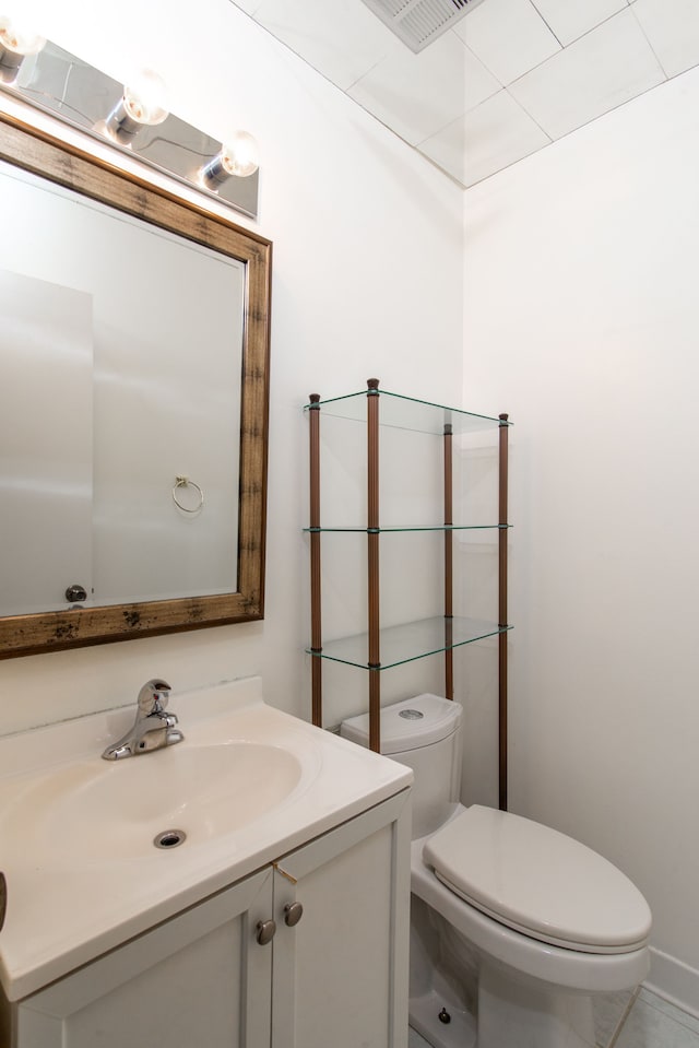 bathroom featuring visible vents, vanity, and toilet