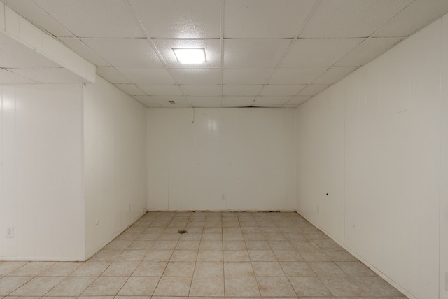 empty room featuring a paneled ceiling