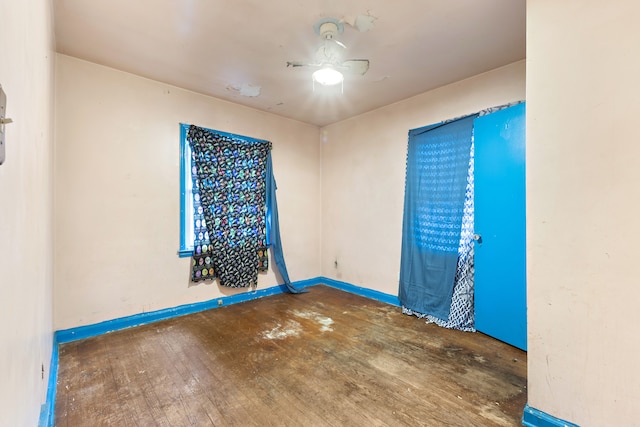 empty room featuring baseboards and hardwood / wood-style flooring