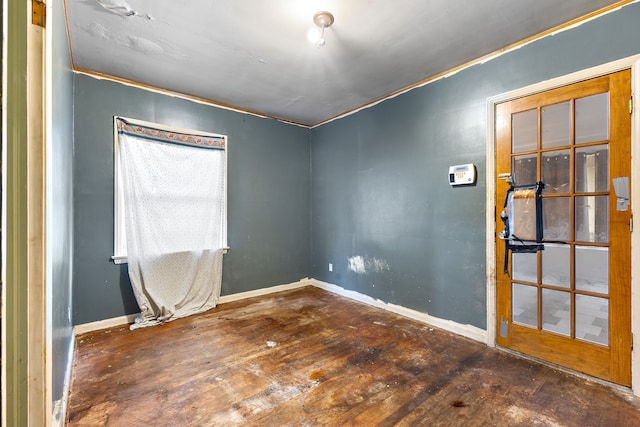 empty room with baseboards and hardwood / wood-style floors