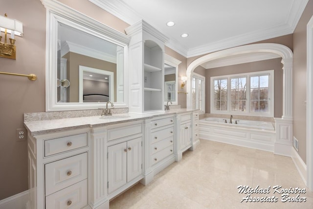 6862 Maplecrest Dr SE, Grand Rapids, MI 49546 - bathroom featuring a garden tub, double vanity, ornamental molding, and a sink