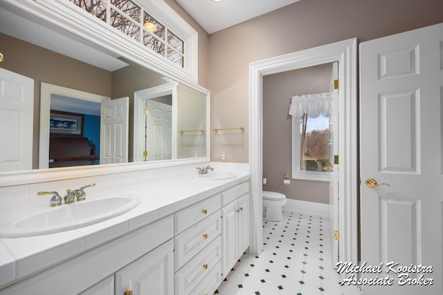 6862 Maplecrest Dr SE, Grand Rapids, MI 49546 - full bathroom featuring toilet, double vanity, baseboards, and a sink