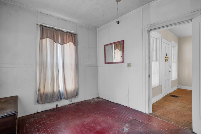 empty room featuring visible vents and wood finished floors