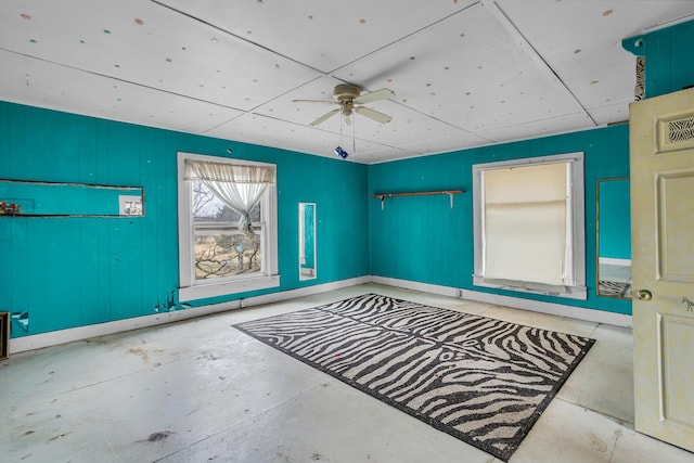 spare room featuring visible vents, concrete floors, and ceiling fan