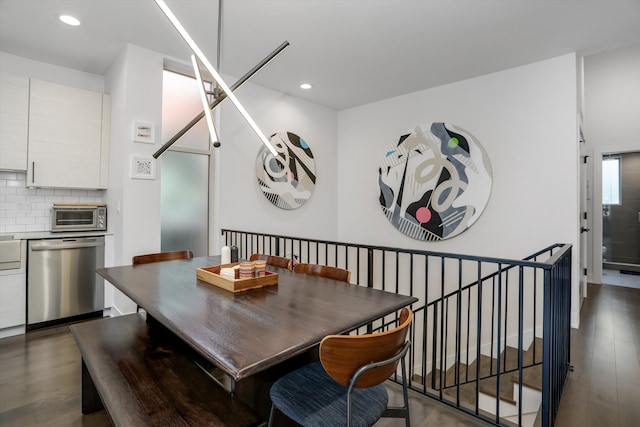 dining area with dark wood-style floors, recessed lighting, and a toaster