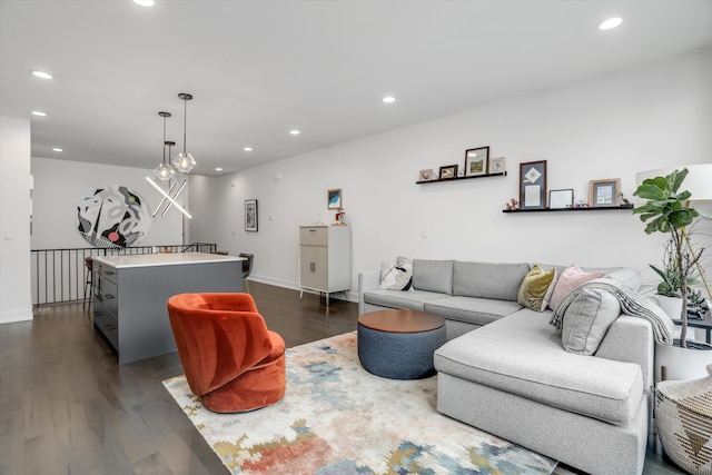 living room featuring baseboards, dark wood-style flooring, and recessed lighting