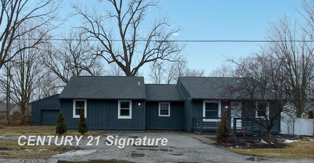 single story home featuring roof with shingles