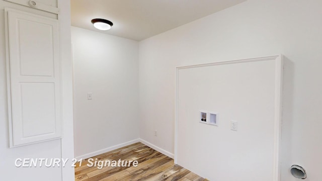 laundry area with hookup for a washing machine, light wood-type flooring, and baseboards