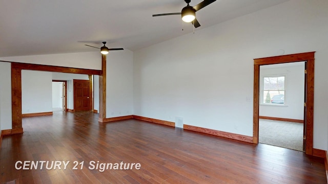 unfurnished living room with ceiling fan, dark wood finished floors, baseboards, and vaulted ceiling