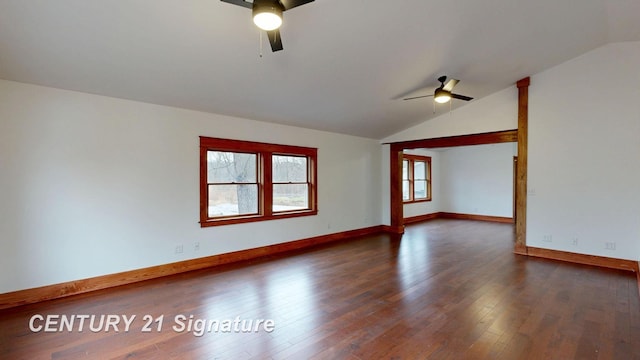 empty room featuring ceiling fan, lofted ceiling, dark wood-type flooring, and baseboards