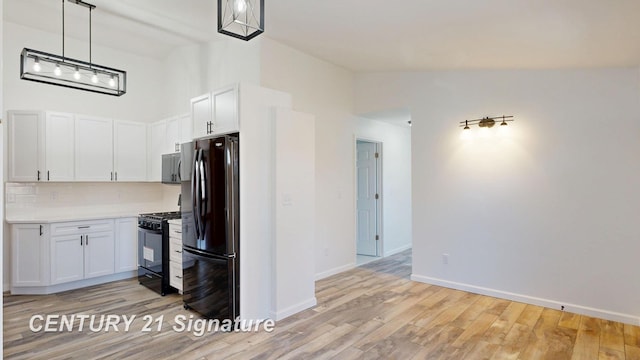 kitchen with black appliances, white cabinetry, light countertops, decorative backsplash, and light wood-type flooring