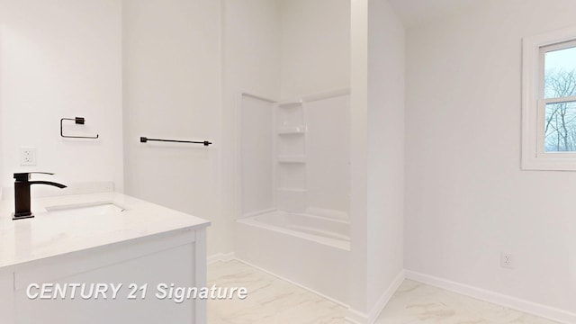 full bathroom featuring marble finish flooring, baseboards, and vanity