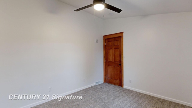 spare room featuring ceiling fan, carpet floors, baseboards, and vaulted ceiling