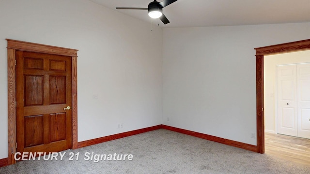 carpeted empty room featuring a ceiling fan and baseboards