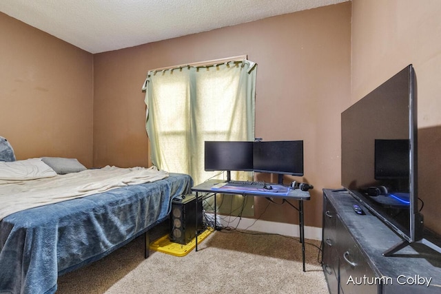 bedroom with a textured ceiling, carpet, and baseboards