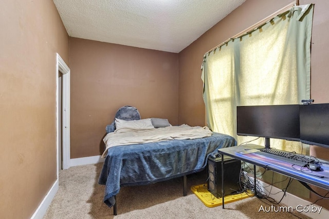 bedroom featuring carpet flooring, a textured ceiling, and baseboards