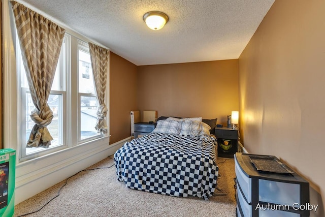 carpeted bedroom with a textured ceiling