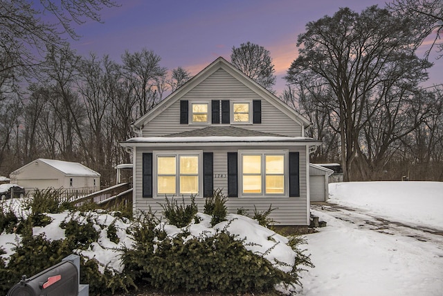 view of front of home featuring a garage and an outdoor structure