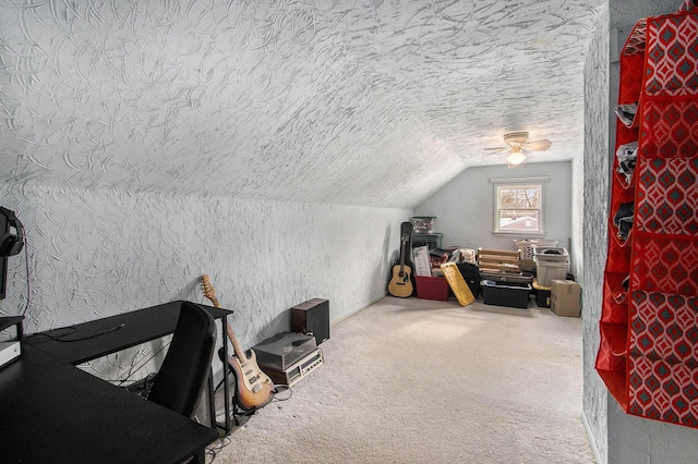 additional living space featuring lofted ceiling, carpet, a textured ceiling, and a ceiling fan