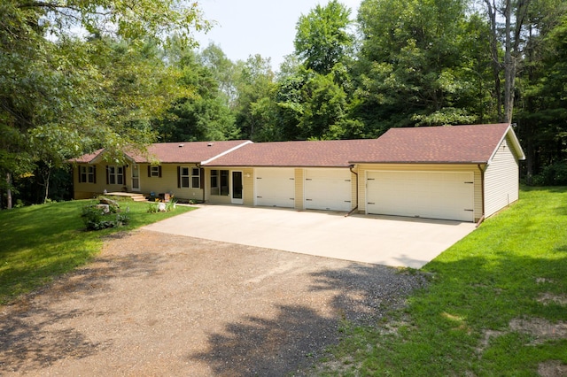 single story home featuring a garage, a front yard, and concrete driveway