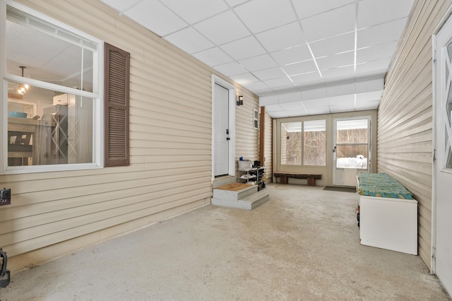 unfurnished sunroom featuring a paneled ceiling