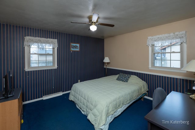 bedroom featuring ceiling fan, a baseboard radiator, and baseboards